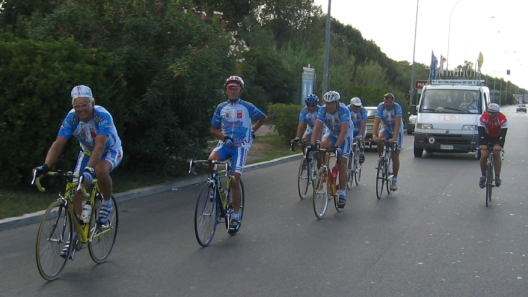An Italian cycling team trains along coast road